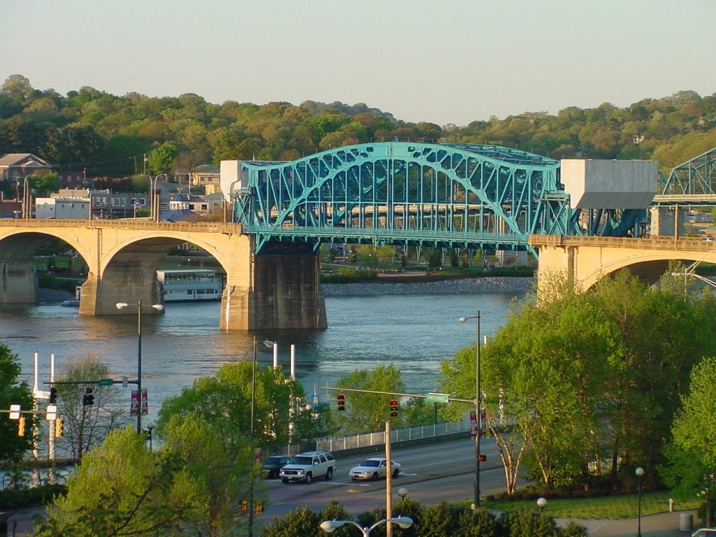 Bridge and riverfront cityscape in Chattanooga, Tennessee during daylight.