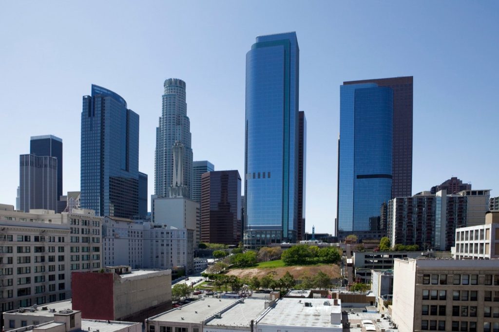 Daytime view of the downtown Los Angeles skyline from an elevated vantage point.