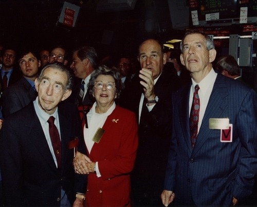 Group of people on the NYSE trading floor during a Reliance-related event.