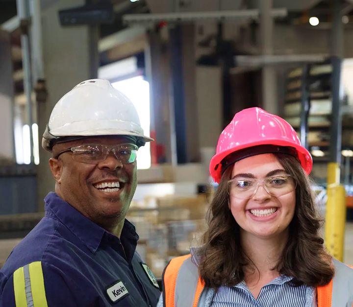 Reliance employees working safely in a metal processing facility following SMART Safety program protocols and hazard recognition practices