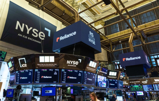 NYSE trading floor with Reliance signs and market screens