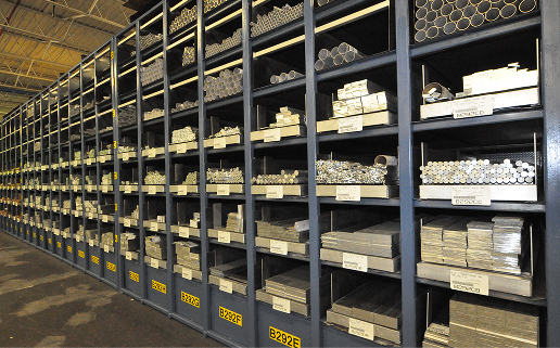 Warehouse shelves stocked with metal bars and tubes