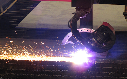 Automated cutting machine slicing metal with sparks