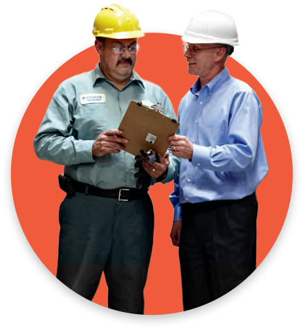 Two workers review a tablet